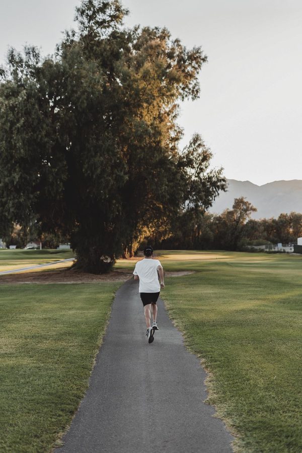 a person running down a path in the middle of a park at The parcHAUS